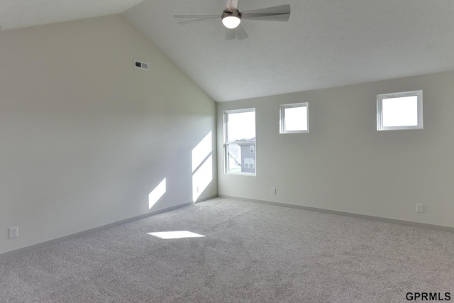 spare room with carpet flooring, ceiling fan, and vaulted ceiling