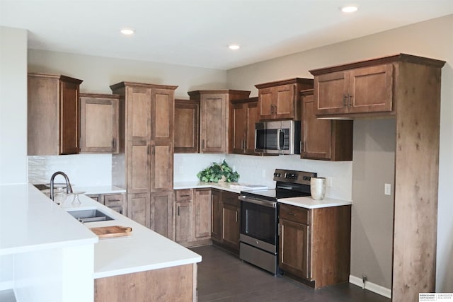 kitchen featuring dark hardwood / wood-style flooring, sink, decorative backsplash, and stainless steel appliances