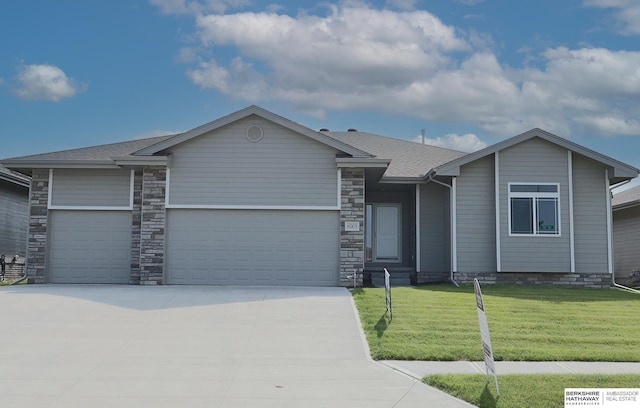 single story home featuring a garage and a front lawn