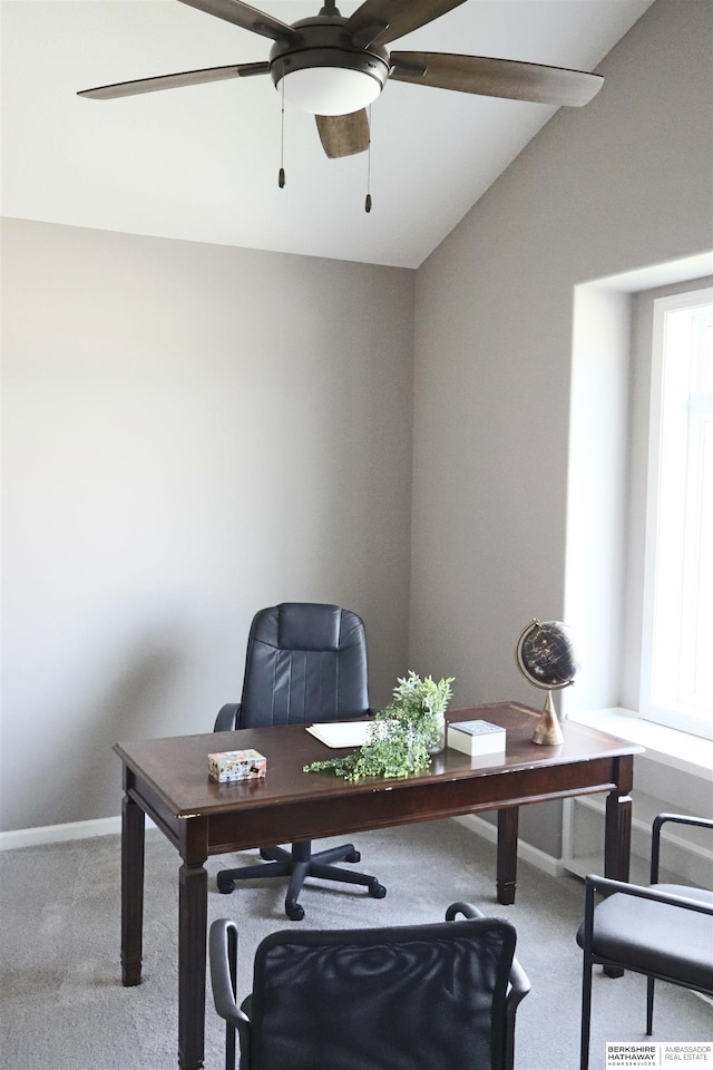 carpeted office space with ceiling fan and lofted ceiling