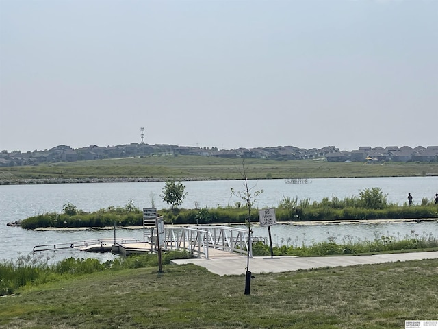 water view with a mountain view and a dock