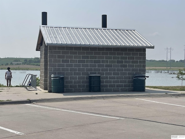 view of side of home with a water view