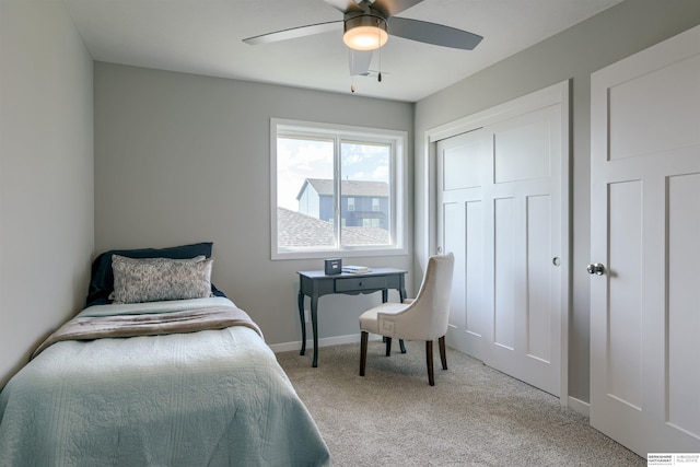 bedroom featuring ceiling fan and light carpet