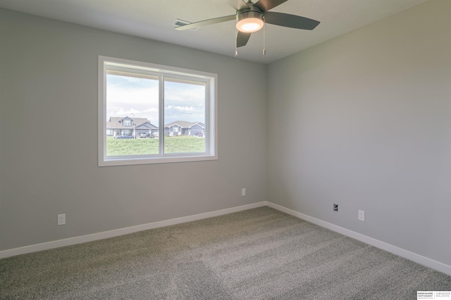 spare room featuring carpet floors and ceiling fan