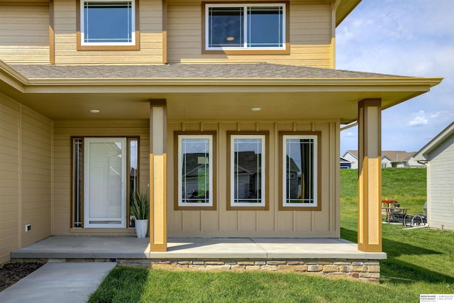 entrance to property featuring a lawn