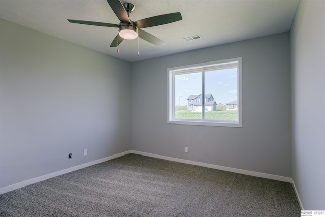 spare room featuring ceiling fan and carpet floors