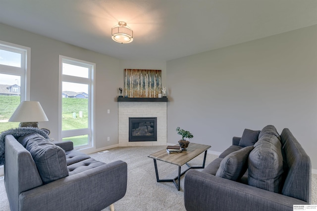 living room with a fireplace and light colored carpet