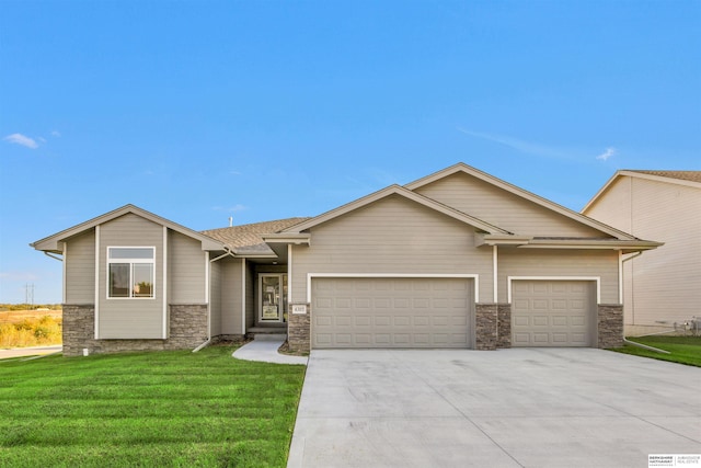 craftsman house with a garage and a front lawn