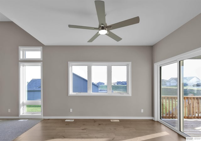 unfurnished room with ceiling fan, a healthy amount of sunlight, and light wood-type flooring