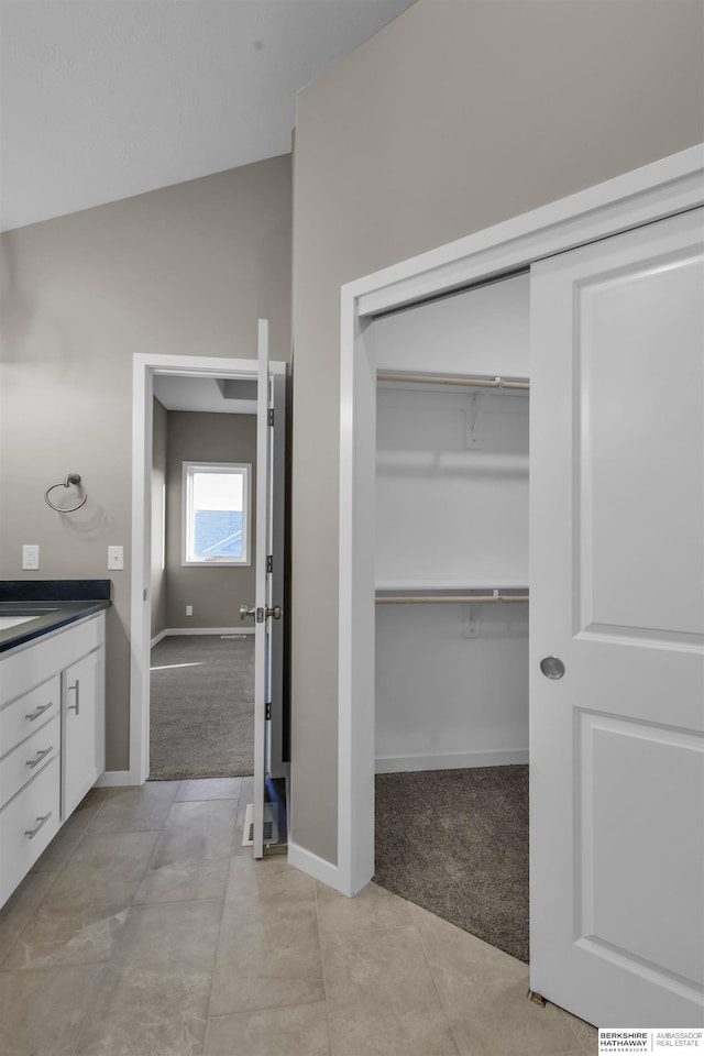 bathroom featuring vanity and vaulted ceiling