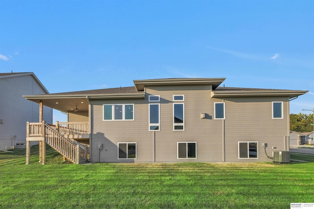 back of house with a lawn and central AC unit