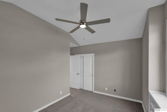 unfurnished room with ceiling fan, light colored carpet, and lofted ceiling