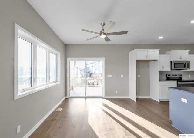 kitchen with ceiling fan, white cabinetry, appliances with stainless steel finishes, and tasteful backsplash