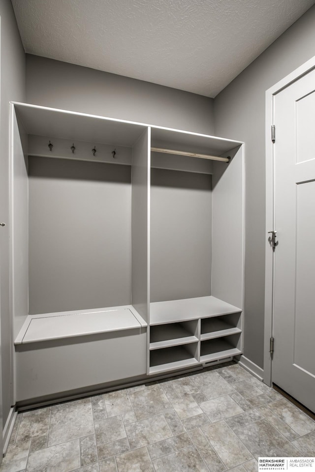 mudroom with a textured ceiling