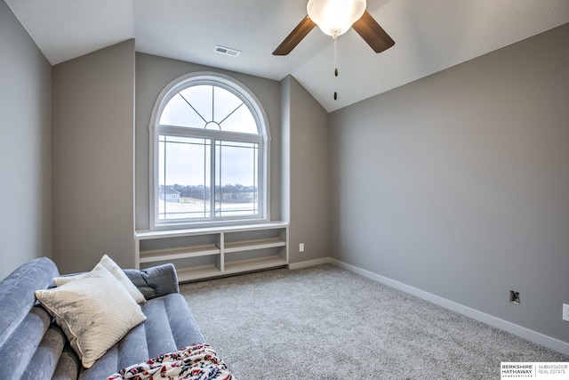 unfurnished room featuring carpet, vaulted ceiling, ceiling fan, and a healthy amount of sunlight