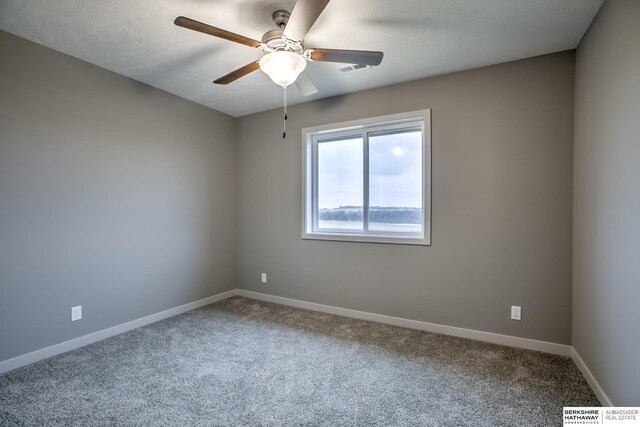 carpeted empty room featuring ceiling fan