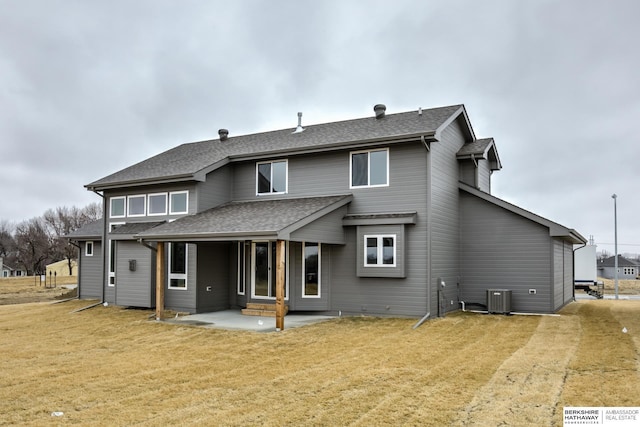 back of property featuring central AC, a patio area, and a yard