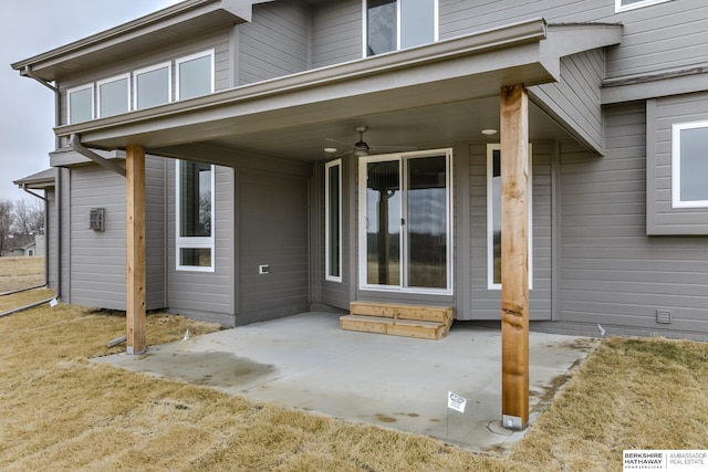 view of exterior entry featuring a patio area and ceiling fan