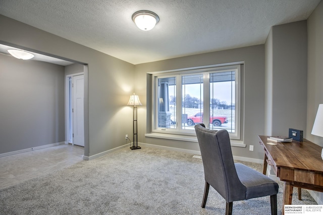 office space with light carpet and a textured ceiling