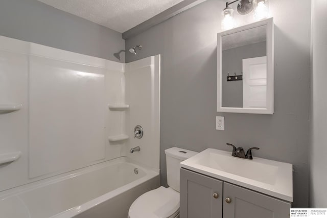 full bathroom with bathtub / shower combination, vanity, a textured ceiling, and toilet