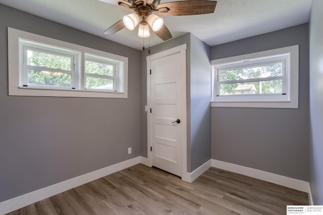 interior space featuring light hardwood / wood-style floors and ceiling fan