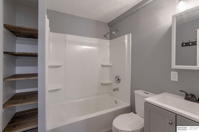 full bathroom featuring shower / tub combination, vanity, a textured ceiling, and toilet