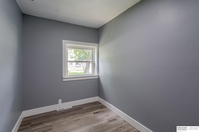 empty room with hardwood / wood-style flooring