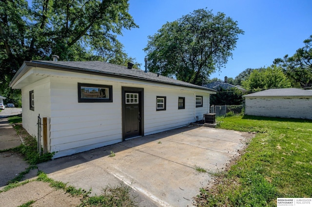 exterior space with a lawn, a patio area, and central air condition unit