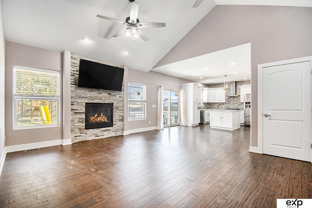 unfurnished living room with ceiling fan, a fireplace, high vaulted ceiling, and dark hardwood / wood-style floors