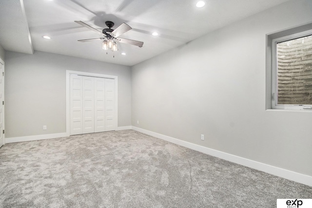 unfurnished bedroom with ceiling fan, a closet, and carpet