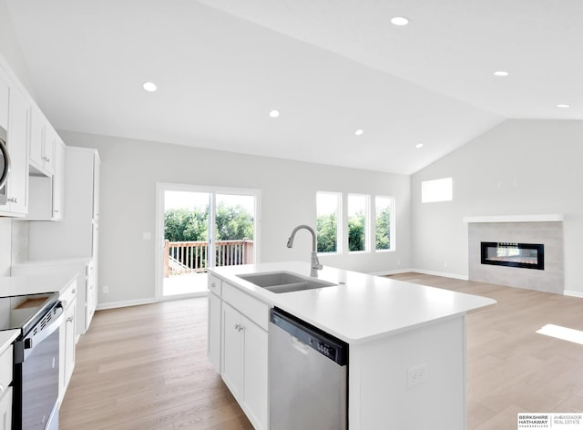 kitchen featuring sink, electric range oven, white cabinets, dishwasher, and an island with sink