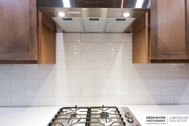 kitchen featuring gas cooktop, backsplash, and extractor fan