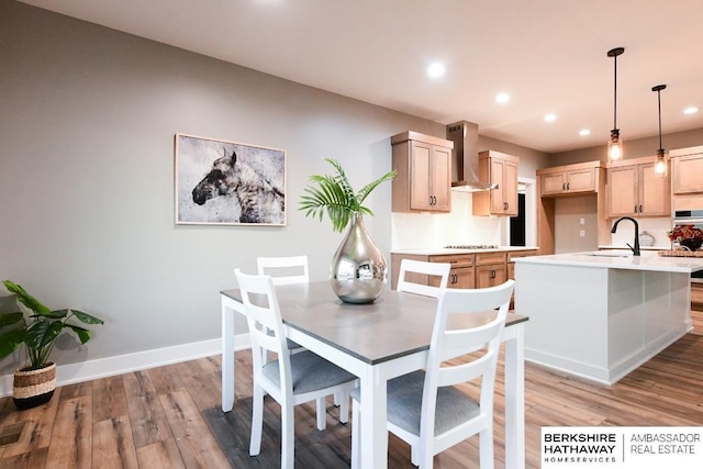 dining space featuring light hardwood / wood-style flooring and sink