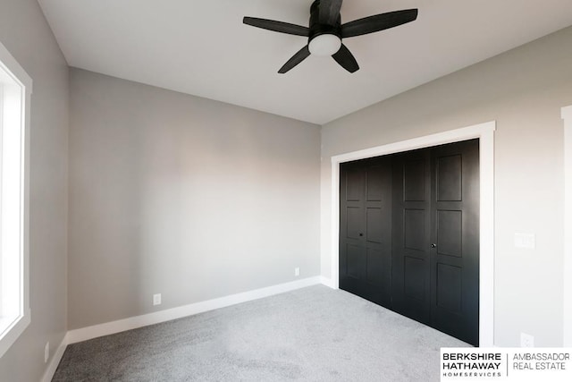 unfurnished bedroom with carpet floors, a closet, and ceiling fan