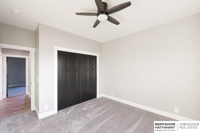 unfurnished bedroom with carpet flooring, ceiling fan, and a closet