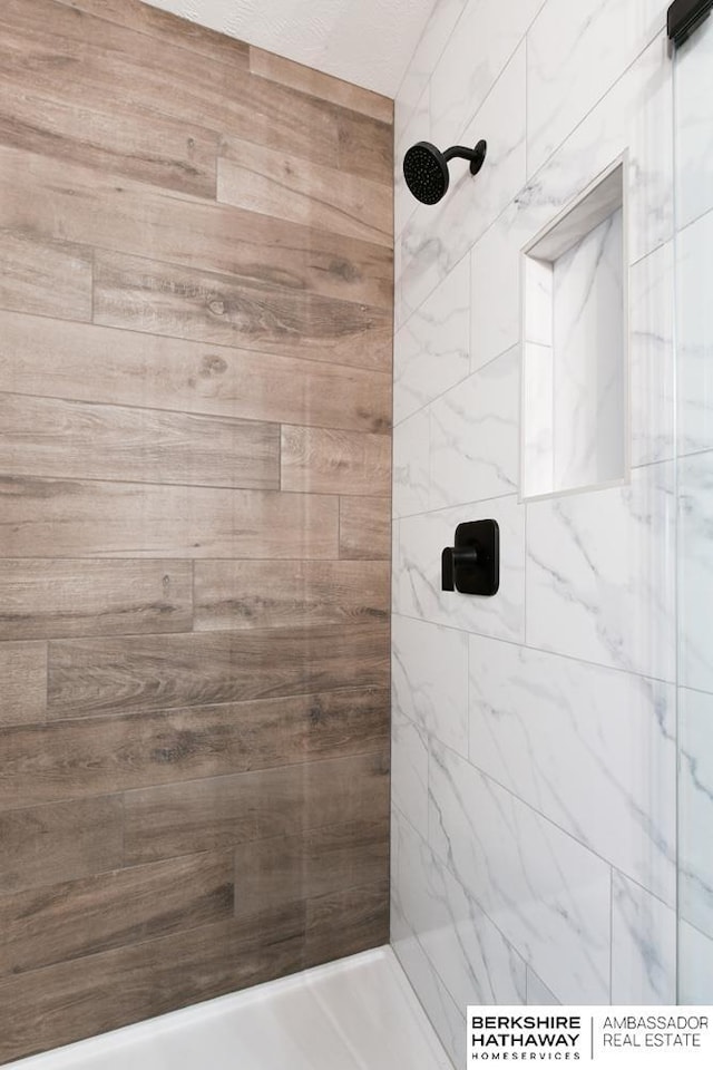 bathroom with a tile shower