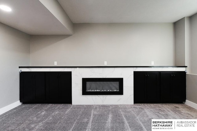 interior space with carpet flooring and a high end fireplace