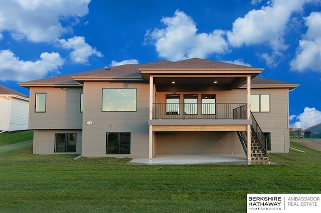 rear view of house with a patio area and a lawn