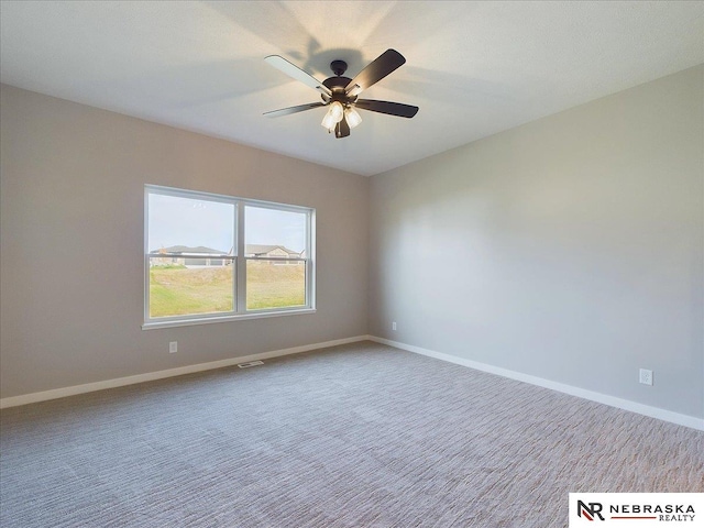 carpeted spare room featuring ceiling fan