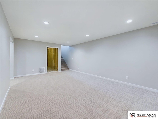 basement featuring light carpet