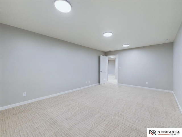 unfurnished room featuring light carpet