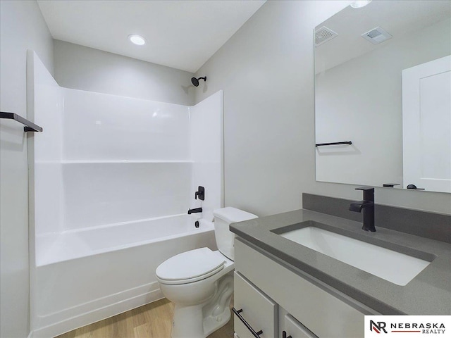 full bathroom featuring vanity, hardwood / wood-style flooring, toilet, and shower / bathtub combination