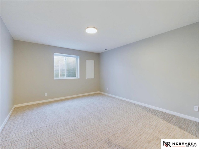 unfurnished room featuring light colored carpet