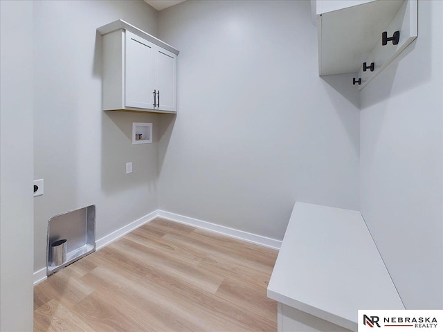 laundry area with cabinets, hookup for a washing machine, light hardwood / wood-style floors, and hookup for an electric dryer