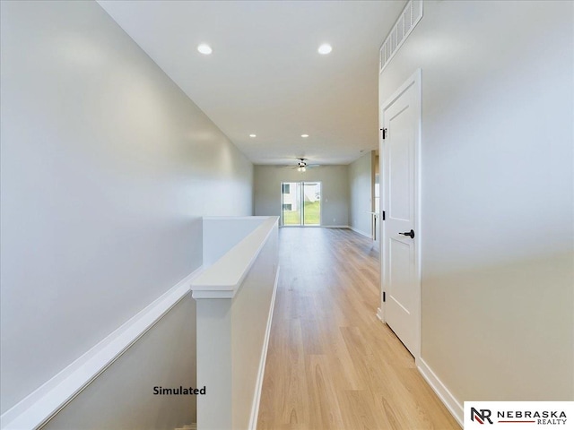 hallway with light hardwood / wood-style floors