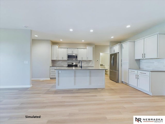 kitchen featuring white cabinetry, light hardwood / wood-style flooring, sink, and appliances with stainless steel finishes