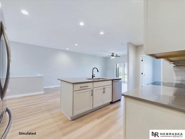 kitchen with light wood-type flooring, white cabinets, sink, a center island with sink, and dishwasher