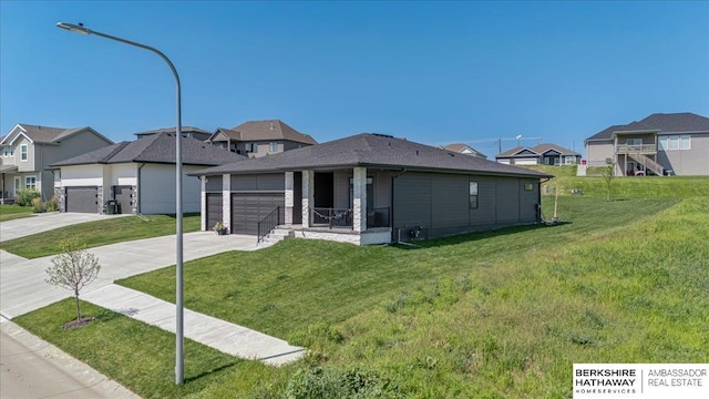 view of front of home with a garage and a front yard