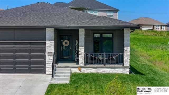 view of front of house with a front yard and a garage