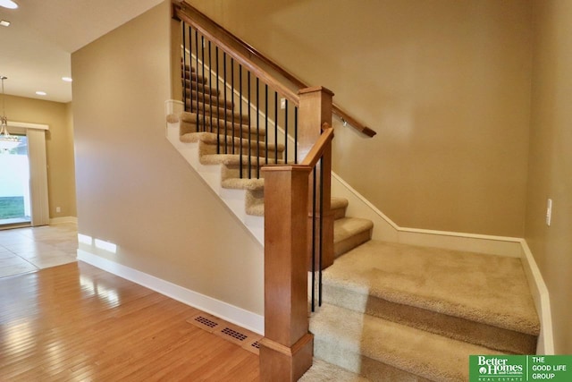 stairs with hardwood / wood-style floors